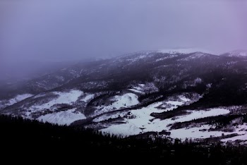 aerial photography of snowfield under white clouds