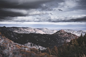 Aerial Photography of Snowy Field Viewing Mountain Under White and Gray Sky