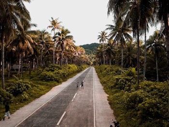 Aerial Photography Of Two People Standing On Road