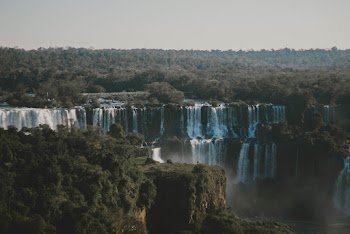 Aerial Photography Of Waterfalls Surrounded By Green Trees