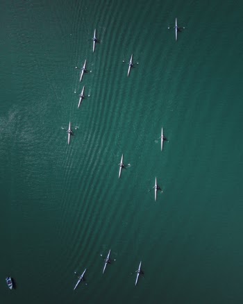 Aerial Photography of White Canoe Lot on Body of Water