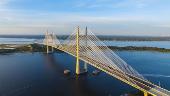 aerial photography of yellow bridge surrounded by body of water