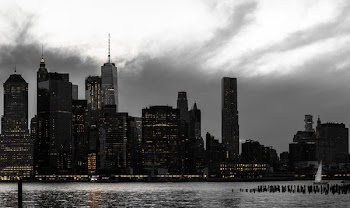 aerial photography skyscraper under gray clouds