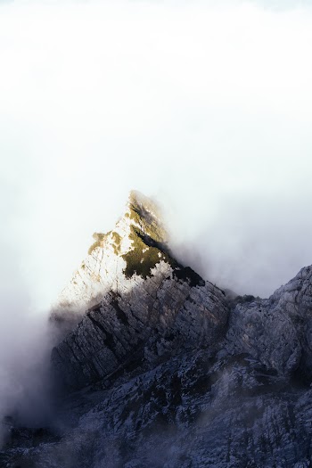 Aerial Shot Of Dense Clouds  Creeping On The Mountain Peak
