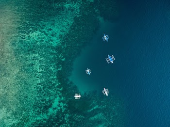 Aerial Shot of Five Boats on the Ocean