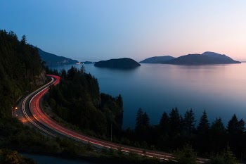 aerial time-lapse photography of highway near sea