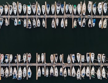 Aerial Two Rows Of Docked Sailboats