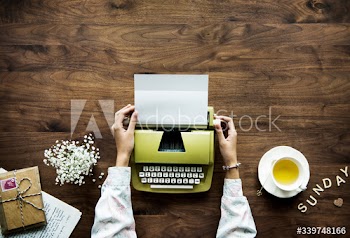Aerial view a woman using a retro typewriter hobby and sunday leisure concept