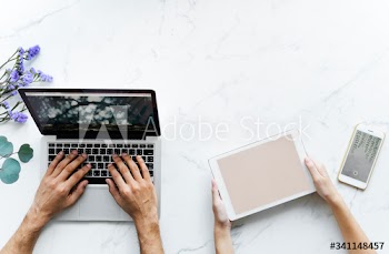 Aerial view of a couple using digital devices