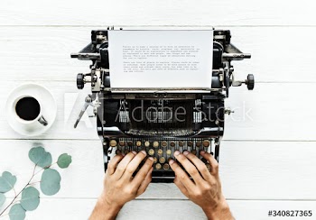 Aerial view of a man typing on a retro typewriter