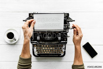 Aerial view of a man typing on a retro typewriter