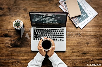 Aerial view of a man using computer laptop on wooden table