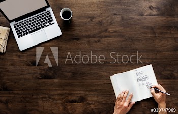 Aerial view of a person drawing font designs and copy space