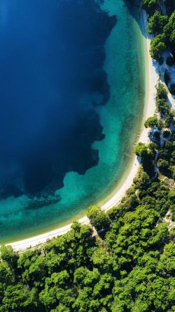 Aerial View of a Serene Coastal Lagoon with Lush Greenery