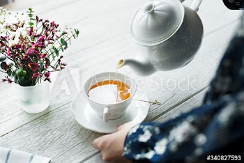 Aerial view of a woman pouring a hot tea drink