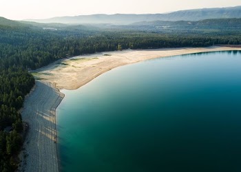 aerial view of blue lagoon and forest