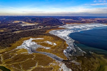 Aerial View of Body of Water, Land Formation, and Mountain