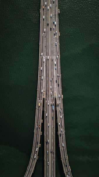 aerial view of bridge with cars crossing