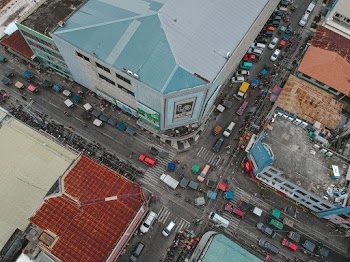 Aerial View Of City Buildings And Vehicles On Road