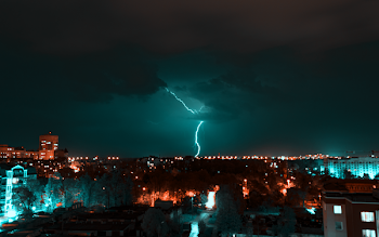Aerial View of City With Thunder