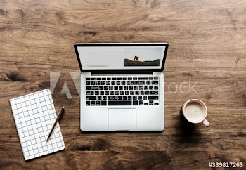 Aerial view of computer laptop on wooden table workspace concept