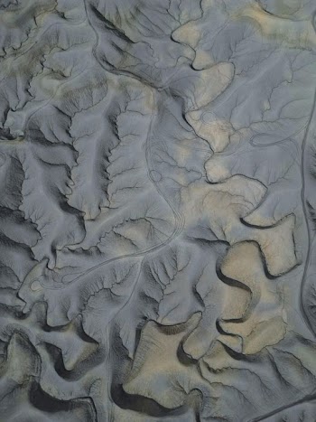 Aerial View of Desert Sand Dunes and Undulating Terrain