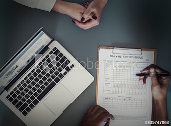 Aerial view of doctor writing patient daily report checklist