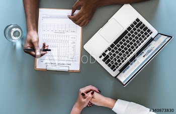 Aerial view of doctor writing patient daily report checklist