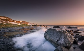 aerial view of gray boulders near seashore
