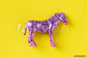 Aerial view of horse figurine toy in a colorful background