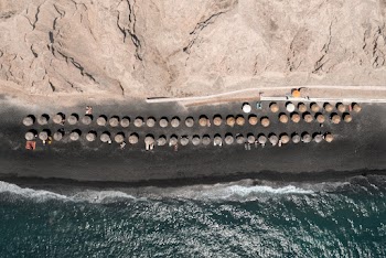 Aerial View Of Huts On Seashore