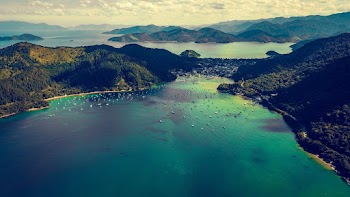 Aerial View of Lake Surrounded by Mountains