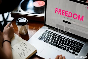 Aerial view of laptop with freedom word on screen