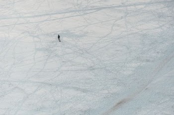 aerial view of person walking on snow covered ground