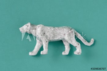 Aerial view of shiny animal figurine tiger with effects