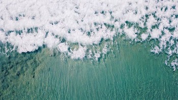 aerial view of waves on beach