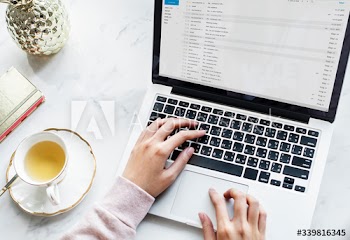 Aerial view of woman using a computer laptop and a cup of tea