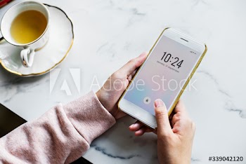 Aerial view of woman using a smart phone and a cup of tea