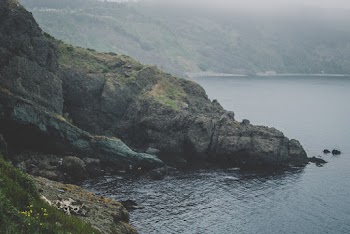 Aerial View Photo of Rocks on Body of Water
