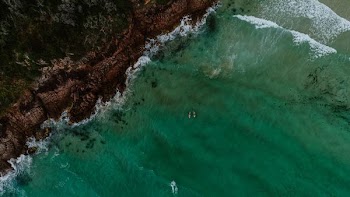 aerial view photography of green ocena water near seashore during daytime