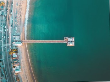 aerial view photography of green sea near dock at daytime