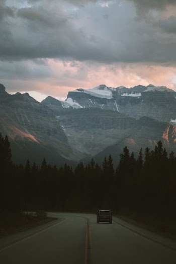 aerial view photography of mountain under cloudy sky