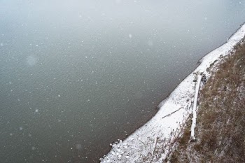 aerial view photography of ocean beside snow-covered shore