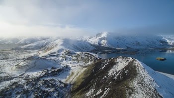 aerial view photography of snow mountain near lake