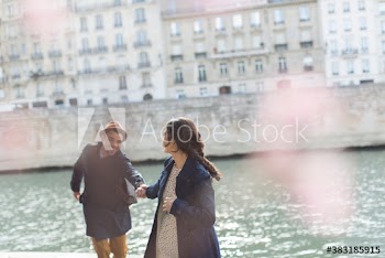 Affectionate couple holding hands at Seine River, Paris, France