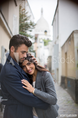 Affectionate couple hugging on Montmartre street, Paris, France