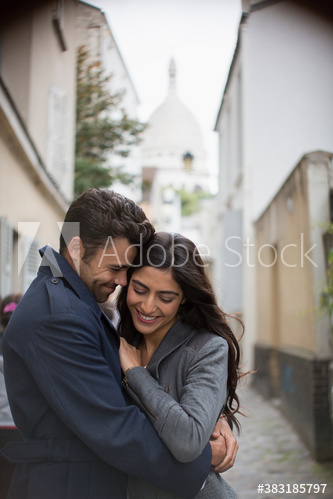 Affectionate couple hugging on Montmartre street, Paris, France