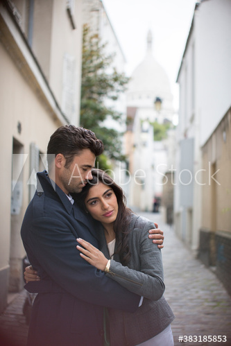 Affectionate couple hugging on Montmartre street, Paris, France