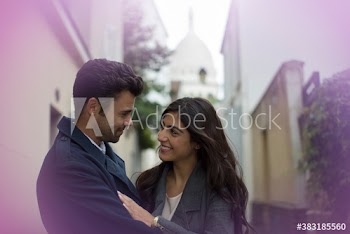 Affectionate couple hugging on street