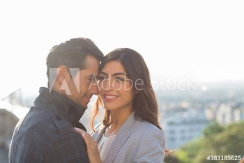 Affectionate couple hugging outdoors